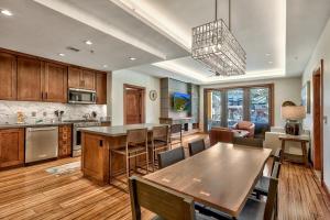 a kitchen with a table and a dining room at Luxury Three Bedroom Residence steps from Heavenly Village condo in South Lake Tahoe