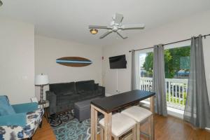 a living room with a table and a couch at Siesta Cool: Only Minutes Walk to Siesta Beach! in Siesta Key