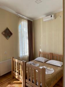 a bedroom with two beds and a window at 1870 Hotel in Kutaisi
