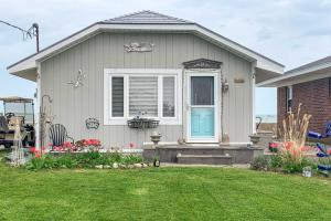 a house with a blue door and a yard at Waterfront Oak Harbor Home on Lake Erie with Views! in Sand Beach
