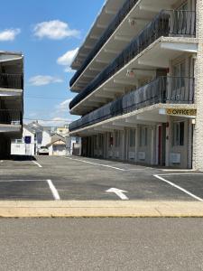an empty parking lot in front of a building at Glendale Motel in Seaside Heights
