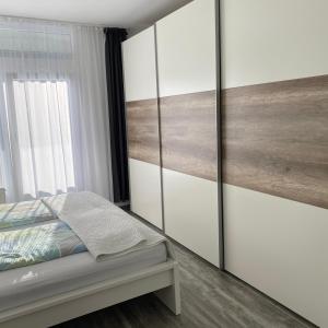 a bedroom with a bed with sliding glass doors at International in Bad Harzburg