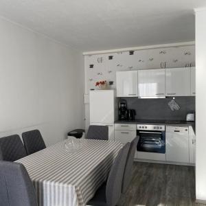 a kitchen with a table and chairs in a room at International in Bad Harzburg