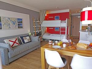 a living room with a couch and a bed at fewo1846 Intermar - Kajuete Foerdeblick - familienfreundliches Studioapartment mit Balkon und Meerblick in Glücksburg +20 photos