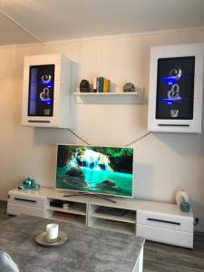 a living room with a flat screen tv at International in Bad Harzburg