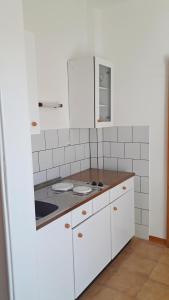 een keuken met witte kasten en een aanrecht bij Apartmani Katica in Diklo +30 foto's