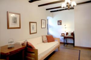 a living room with a white couch and a table at Casa Rural Donamariako Benta in Donamaría