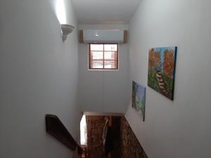 a staircase with two pictures on the wall and a window at casa na aldeia - entre Fundão e Covilhã in Pêro Viseu +34 photos
