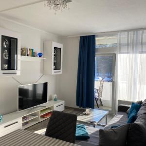 a living room with a couch and a television at International in Bad Harzburg +12 photos