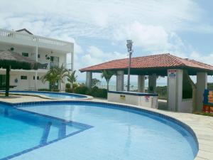 a large swimming pool in front of a building at apartamento em jacumã- residencial granito x jasmim in Jacumã