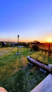 a park with a log laying on the grass at Cabañas Atardecer en Victoria in Victoria