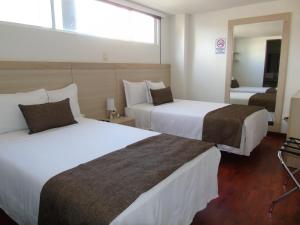 Voodi või voodid majutusasutuse Hotel Paradise del Cafe toas