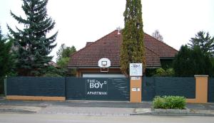 a building with a sign on the side of it at The Boys Apartman in Siófok