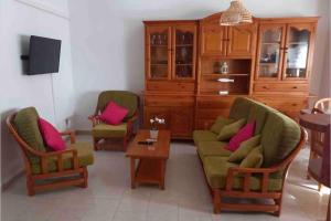 a living room with two chairs and a table at Casa Castro in Els Muntells