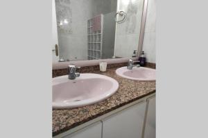 a bathroom with two sinks and a large mirror at Casa Castro in Els Muntells +7 photos