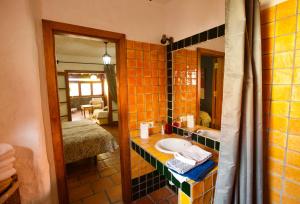 een badkamer met een wastafel en een spiegel bij Finca Eva-Adults 0nly in La Playa Calera