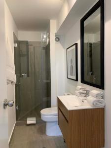 a bathroom with a toilet and a sink and a shower at Bright 1BR in Barranco in Lima