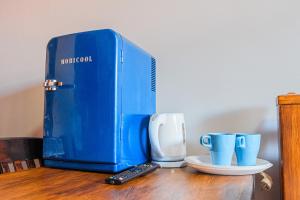a blue box sitting on top of a table with cups at SAMARIANKA hotel in Kolomiya