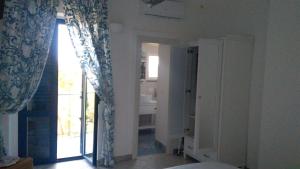 Zimmer mit einer Tür zu einem Bad mit einem Fenster in der Unterkunft Appartamento in Residence Pollio in Policastro Bussentino