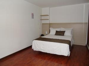 Voodi või voodid majutusasutuse Hotel Paradise del Cafe toas