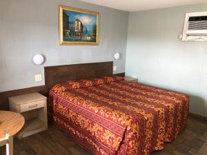 a hotel room with a bed and a picture on the wall at Budget inn in Kingsville