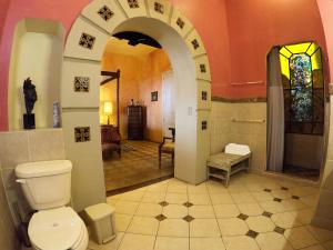 a bathroom with a toilet and a walk in shower at La Perla Hotel Boutique B&B in Guadalajara +30 photos