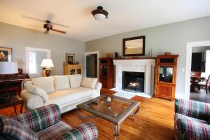 a living room with a couch and a fireplace at The Pines Cottages in Asheville