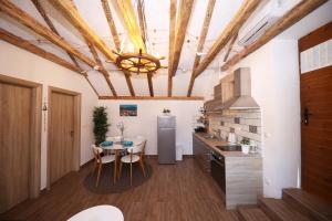 a kitchen with a table and a refrigerator at Apartmani Dvor Betina in Betina
