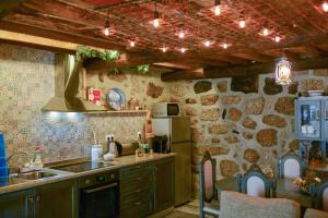 a kitchen with a sink and a refrigerator at Casa dos Alcaides in Sabugueiro