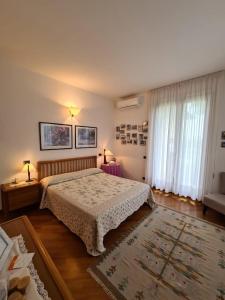a bedroom with a bed and a large window at Marinella B&B in Cornale