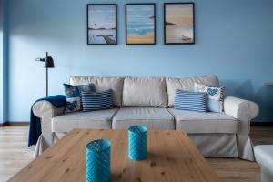 a living room with a couch and a coffee table at Apartamenty Apartinfo Jasny Brzeg in Władysławowo