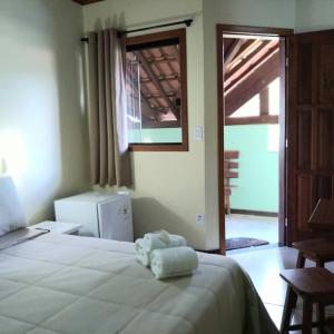 Säng eller sängar i ett rum på Pousada Guimaraes