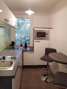a small kitchen with a sink and a counter top at Velden - Villa right in the center with private parking in Velden am Wörthersee