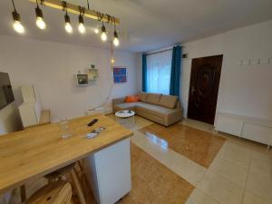 a living room with a table and a couch at Relax Spiral House in Oradea