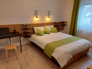 a bedroom with a bed with a desk and a laptop at Relax Spiral House in Oradea +19 photos