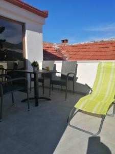 a patio with a table and chairs on a balcony at VILA MIRA in Trebinje