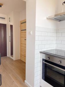 cocina con paredes blancas y fogones horno superior en Apartament Sopot en Sopot