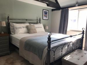 a bedroom with a bed and a window at No 91 The Loft Odiham - Self Catering apartment Min 2 Night stay in Hook