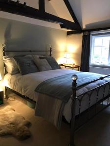 a bedroom with a large bed in a room at No 91 The Loft Odiham - Self Catering apartment Min 2 Night stay in Hook