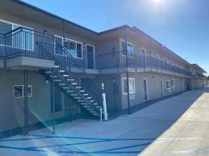 a building with a staircase on the side of it at Regency Motel in Brea