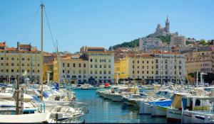 Une bande de bateaux amarrés dans un port avec des bâtiments dans l'établissement Panier, à Marseille