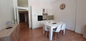 a kitchen with a white table and white chairs at Casa Stella in Castel di Sangro