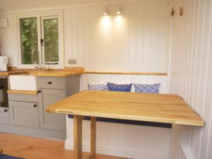 a kitchen with a wooden table in a room at Wolstonbury Getaway in Hassocks