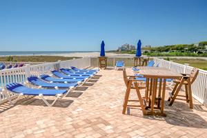 a group of lounge chairs and tables on the beach at Sands Beach Club in Myrtle Beach