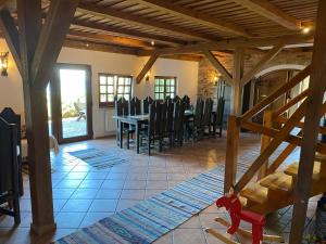 a dining room with a table and chairs at Mazurska Zagroda in Rydzewo +71 photos