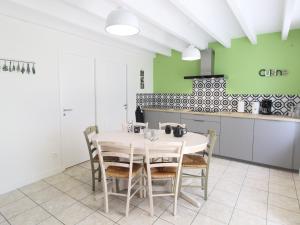 a kitchen with a table and chairs in a room at Gîte Chemillé-en-Anjou-Chemillé-Melay, 4 pièces, 6 personnes - FR-1-622-8 in Saint-Georges-du-Puy-de-la-Garde