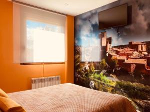 a bedroom with a large painting on the wall at Apartamentos Numancia in Garray