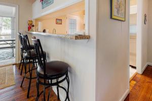 a kitchen with four bar stools at a counter at Bethany West - 609 Brookview in Bethany Beach