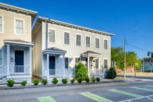 a white house with blue accents on a street at Price Street Place in Savannah