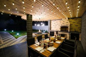 a dining room with a table and a stage at SHIMresidence LUXURY in Rădăuţi